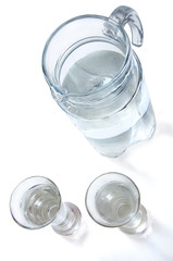 decanter and two glass with clean water, top view