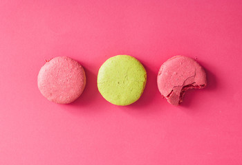 Colorful macaroons cakes on pink background