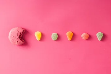 Poster Macaroon with jelly beans on pink background © Zamurovic Brothers