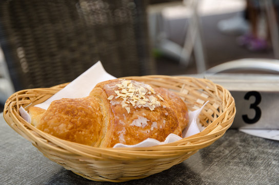 Single croissant in a basket