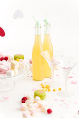 Lemonade, glasses and sweets on the table