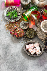 Tea table place setting colorful glasses. Oriental hospitality