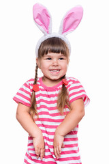 Happy little girl with pink rabbit ears. Portrait of cute caucasian baby wearing bunny ears. Funny preschool child, isolated on white background. Healthy carefree kid - Easter holidays concepts.