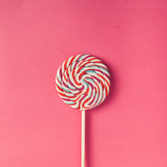 Colorful lollipop on pink background.