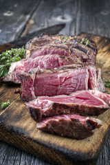 Barbecue Rib Eye Steak aufgeschnitten auf alten Schneidebrett