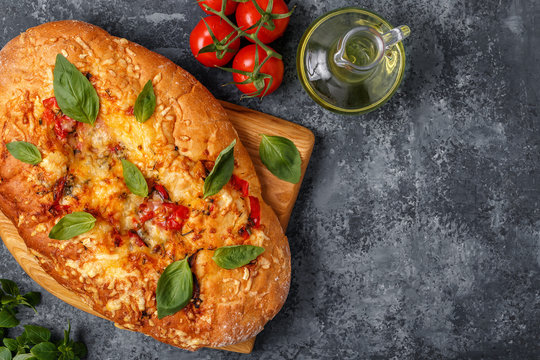 Focaccia with tomatoes, herbs and cheese.