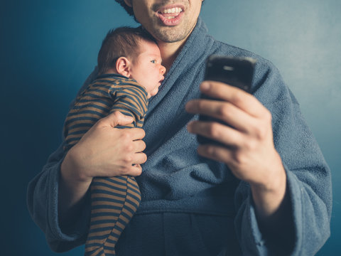 Father taking selfie with baby