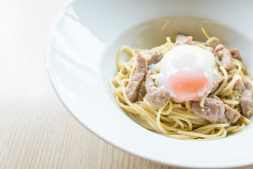 Hot Spaghetti and fried sliced pork with garlic top up with onse