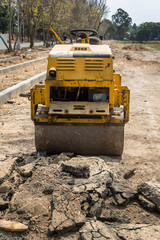 Yellow road roller in construction site