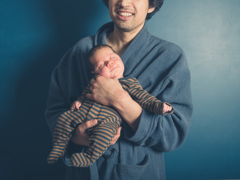 Happy young man with baby son