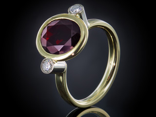 Golden ring with gemstone isolated on black background