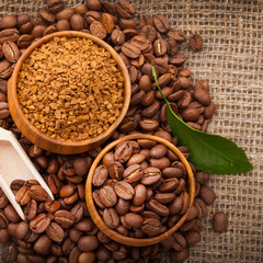 Cup full of coffee beans on the cloth sack