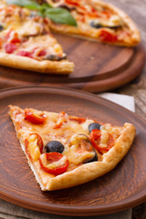 Big tasty pizza with seafood, tomatoes on wooden table