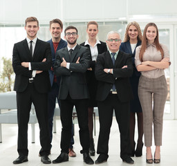 Obraz premium Mature businessman and cheerful business team on office backgrou
