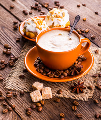 Coffee cup and coffee beans on table