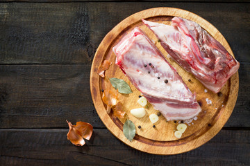 Salty lard with spices and parsley on a wooden background. Top v