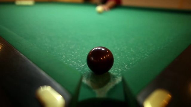 billiard balls on green baize in the game of pyramid