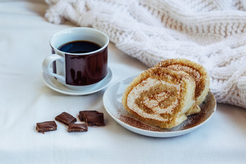 cakes and a cup of hot coffee in the bed, lazy morning, warm winter mood