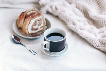 vintage Cup of hot coffee with cookies on white cotton background with blanket
