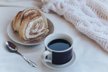 Breakfast with coffee and cookies, spoon, white blanket. Instagram toned photo