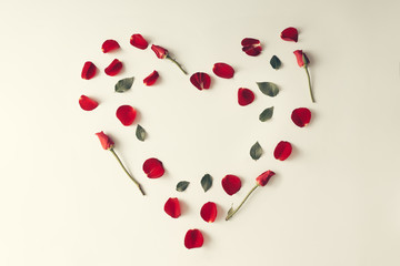 Red rose petal, leaves and flowers in a heart shape - Love conce