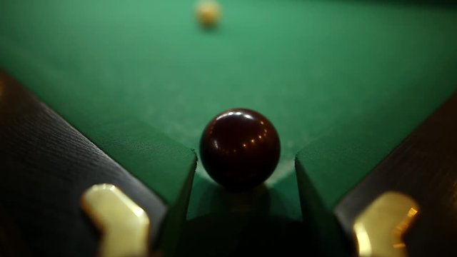 billiard balls on green baize in the game of pyramid