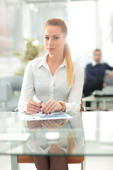 Young business woman standing with her collegues in background a