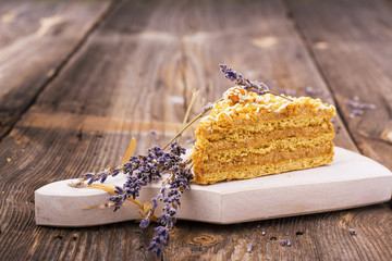 Fototapeta premium Homemade honey cake on a wooden table. Rustic style.