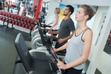 fit woman working out on stepping machine in gym