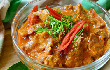 Thai menu  Panaeng Curry with beef and fresh kaffir lime leaves,coconut sugar and sliced chili .
Beef in ground peanut-coconut cream curry.