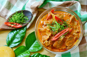 Thai menu  Panaeng Curry with beef and fresh kaffir lime leaves,coconut sugar and sliced chili .
Beef in ground peanut-coconut cream curry.
