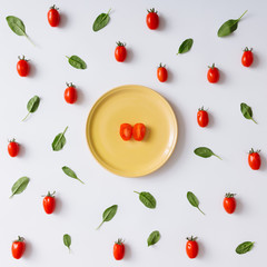 Cherry tomatoes and basil leaves pattern.