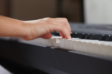 female's  hands playing piano