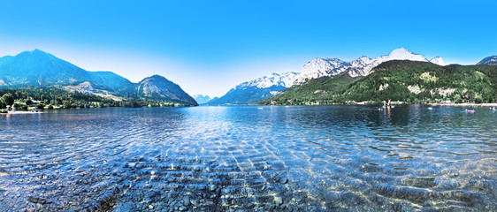 beautiful mountains landscape with water sea and green gras daylight daytime © Sebastian