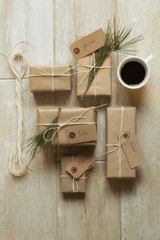Holiday gifts wrapped with string and a cup of coffee