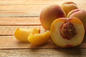 Fresh juicy peaches on wooden background