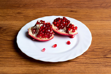 Pomegranate slices and garnet fruit seeds on table. Pomegranate whole. Use