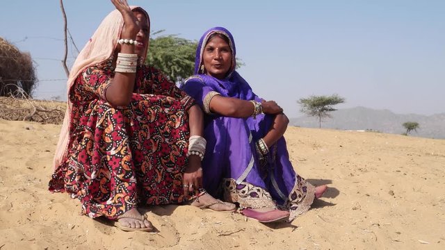 Tilt up to two friends of a nomadic tribe in the Thar desert, India 