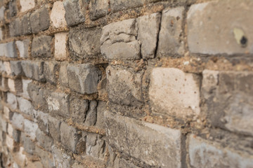 Retro brick wall with destroyed in shades of gray side view