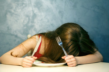 Hungry young woman waiting with an empty plate.