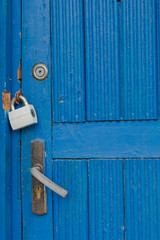 Blue old door with three locks