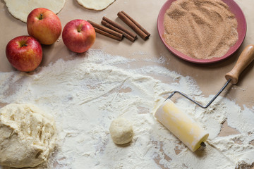 Ingredients for preparation cookies with cinnamon, cottage cheese and apples on kraft paper. Top view. Flat composition. Homemade pastries. Christmas tradition baking, cakes biscuits. Very tasty.
