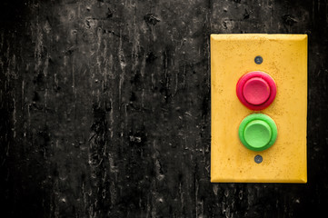 Yellow panel with rempty red and green buttons over dark background