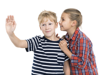 Girl whispering boys ear, when he pushing an imaginary button, isolated white background