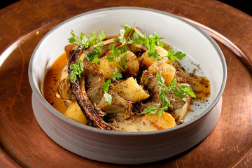 Roasted potato with artichokes and truffles