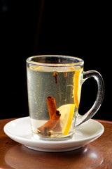 Glass cup with hot punch for winter and Christmastime with berries and wine
