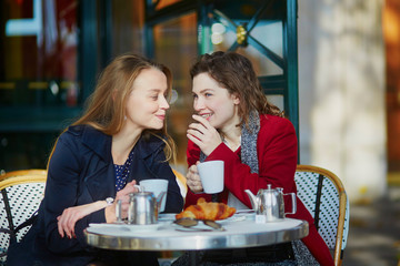 Two young girls in Parisian outdoor cafe