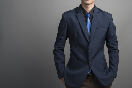 Close Up Of Businessman In Blue Suit Confident On Gray Backgroun