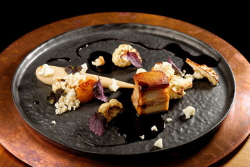 Plated freshly grilled pork belly with potato purree and popcorn/fine dining