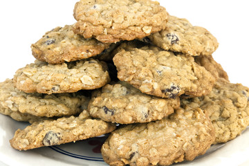 Close-up of a stack of homemade oatmeal raisin cookies on a plate. Horizontal.